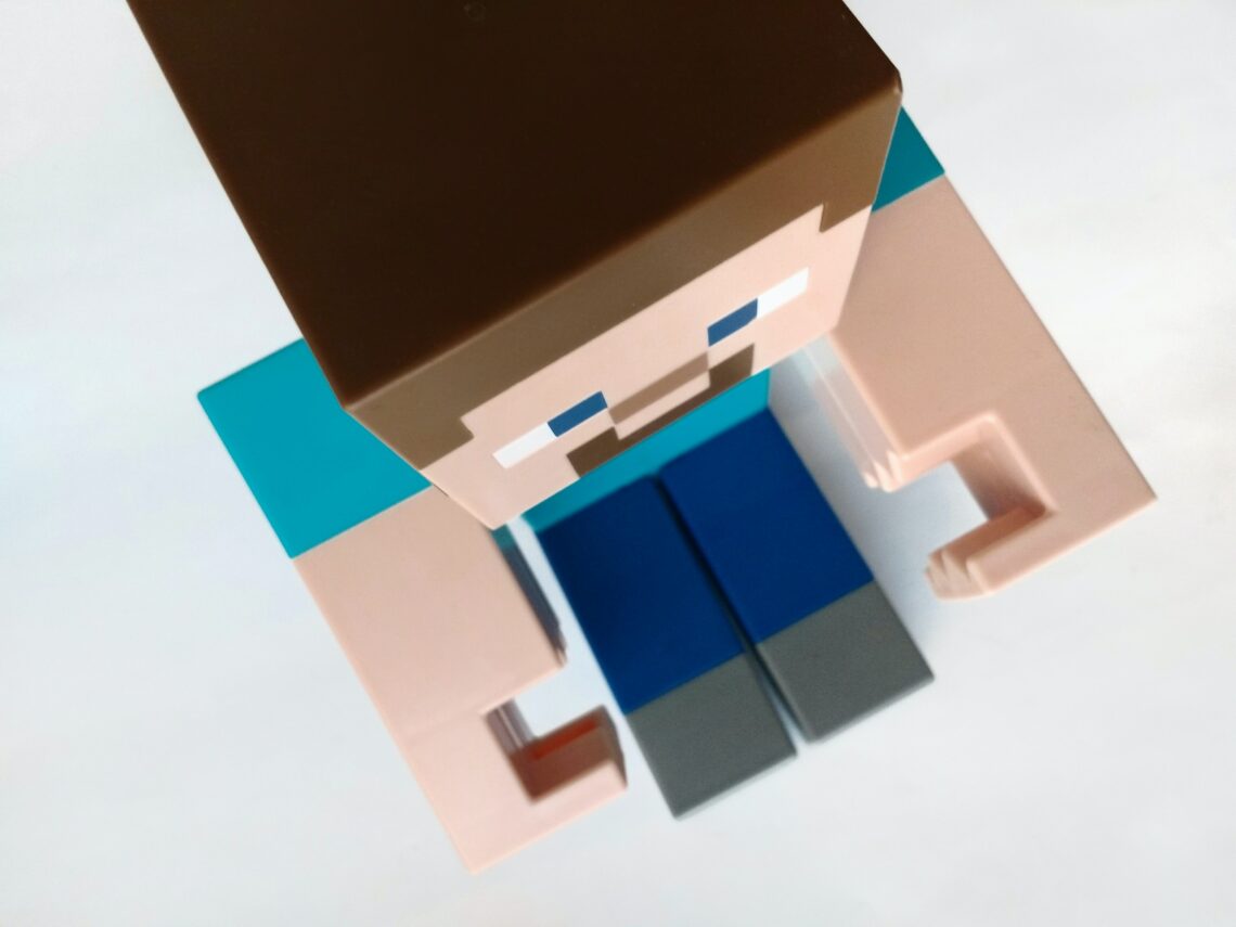 A Minecraft avitar from above. Brown hair, light blue shirt, dark blue pants, light skin.